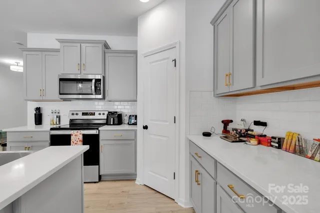 a kitchen with cabinets and appliances