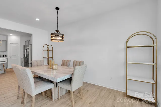 a dining room with furniture a rug and wooden floor