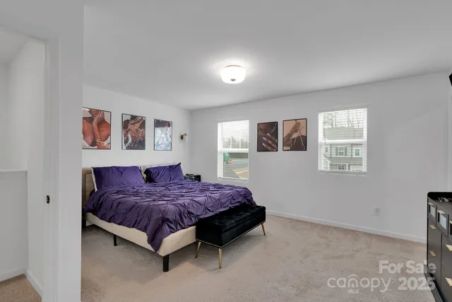 a spacious bedroom with a bed and a window