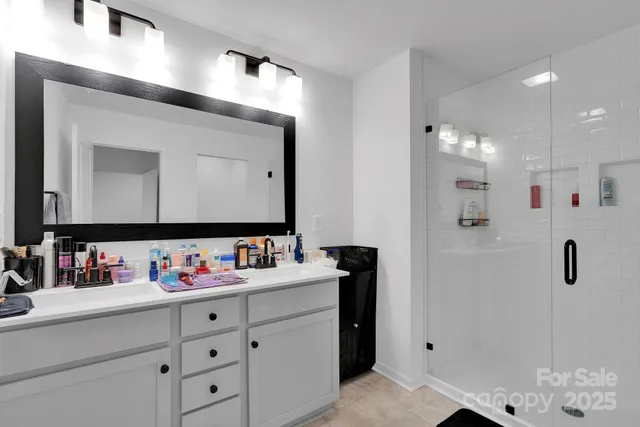 a bathroom with a sink vanity and mirror