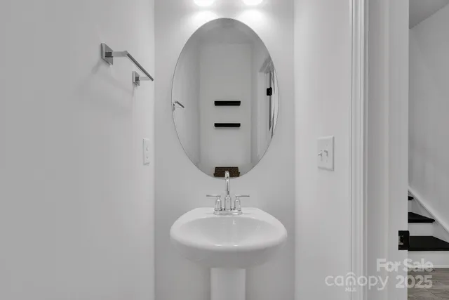 a bathroom with a sink a mirror and a shower