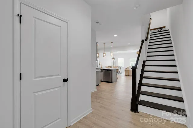 a view of entryway and hall with wooden floor