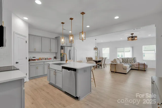 a kitchen with counter top space and living room
