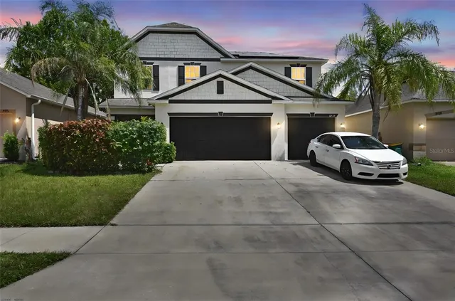 a front view of a house with a yard and garage
