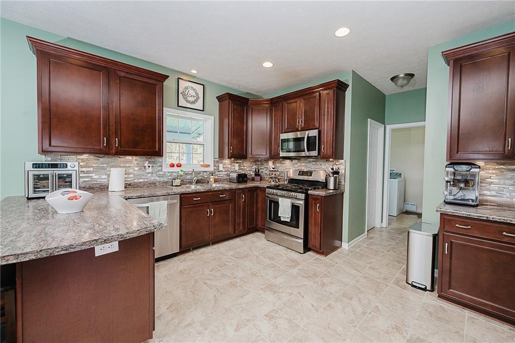 2831 Rte 286 Highway East Indiana, PA 15701 - Photo 14 of 40 a kitchen with stainless steel appliances granite countertop a stove refrigerator sink and cabinets