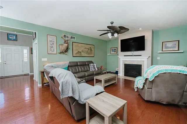 a living room with furniture flat screen tv and a fireplace