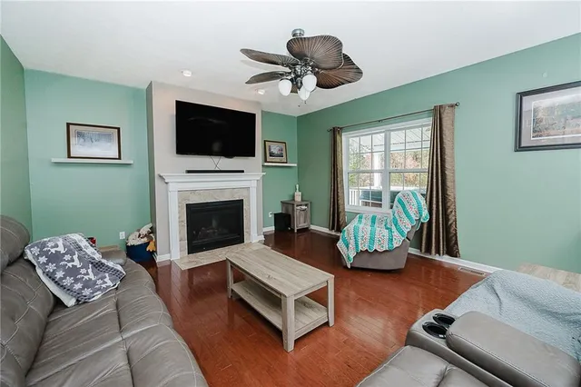 a living room with furniture and floor to ceiling window
