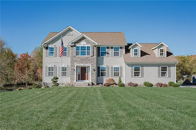 a front view of a house with a yard