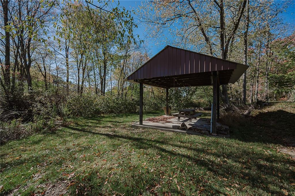 2831 Rte 286 Highway East Indiana, PA 15701 - Photo 38 of 40 a backyard of a house with table and chairs under an umbrella