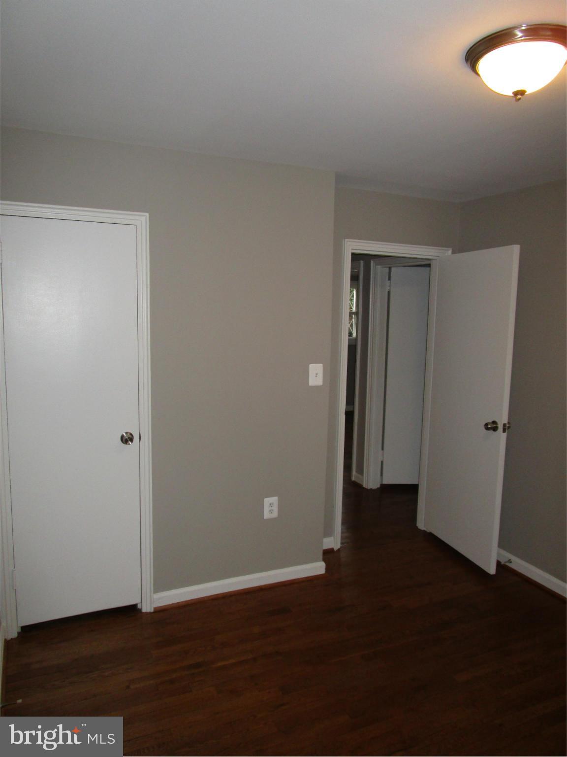 12704 Holdridge Road Silver Spring, MD 20906 - Photo 10 of 22 an empty room with wooden floor and closet