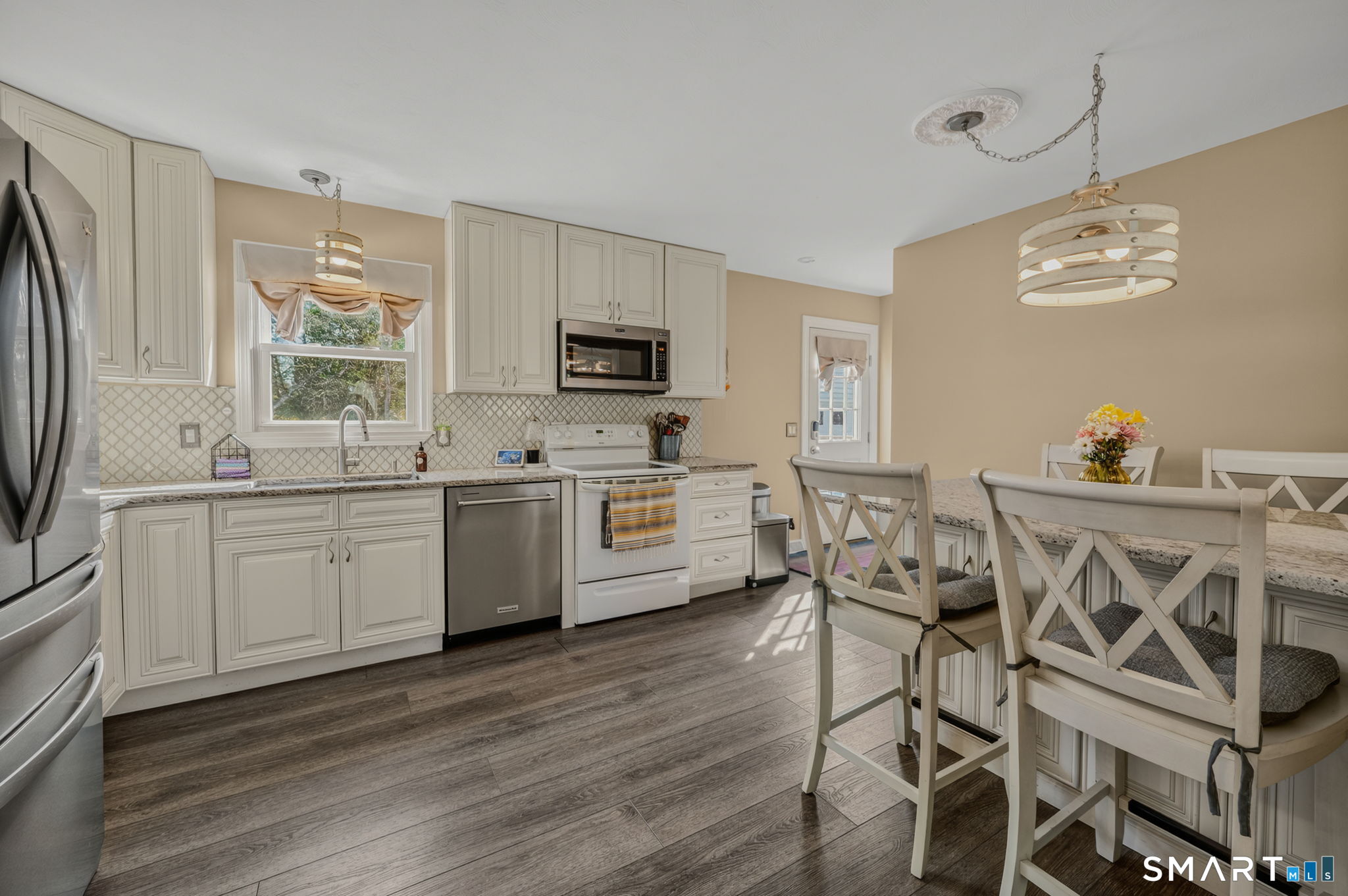 194 Browning Road Norwich, CT 06360 - Photo 6 of 38 a kitchen with stainless steel appliances kitchen island granite countertop a stove a sink and a refrigerator with wooden floor