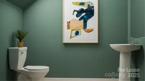 a bathroom with a toilet and a sink