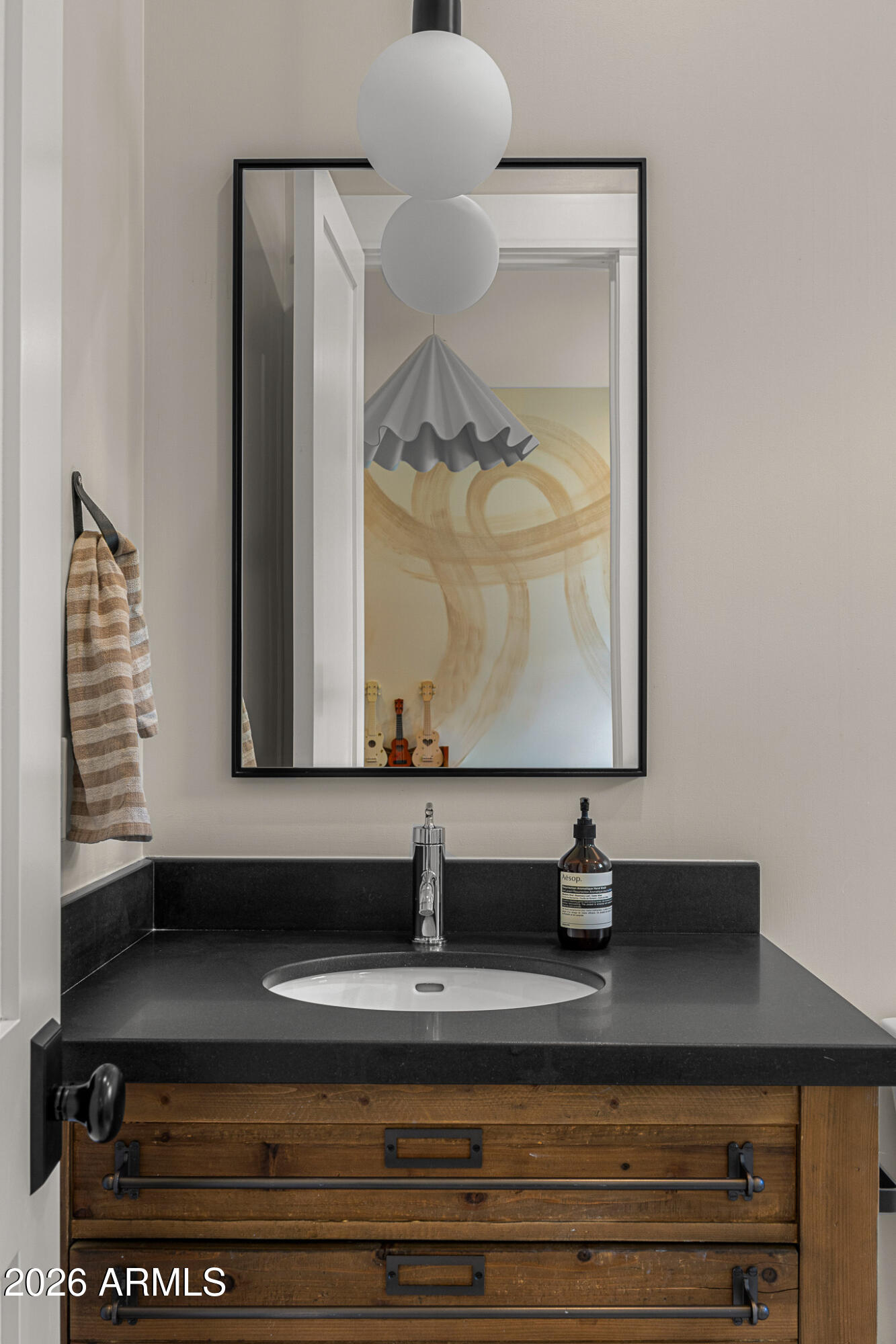 4204 North 57th Way Phoenix, AZ 85018 - Photo 26 of 34 a bathroom with a sink and a mirror