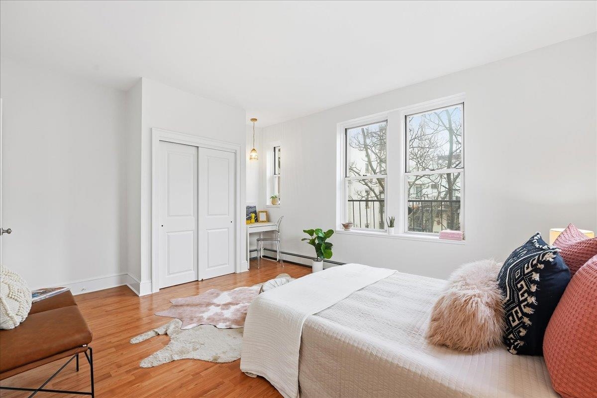 831 Clinton Street, Unit 9 Hoboken, NJ 07030 - Photo 11 of 20 a bedroom with a bed and a window
