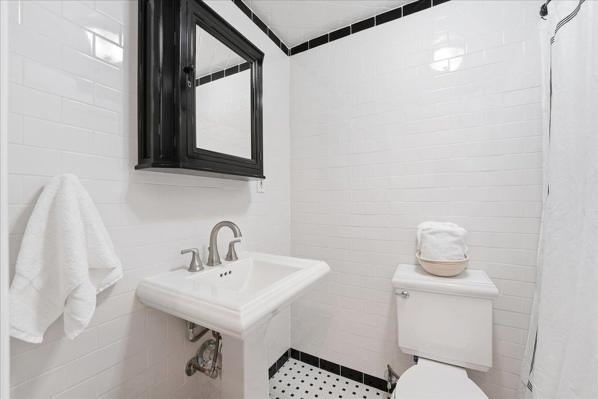 831 Clinton Street, Unit 9 Hoboken, NJ 07030 - Photo 13 of 20 a bathroom with a sink a toilet and mirror