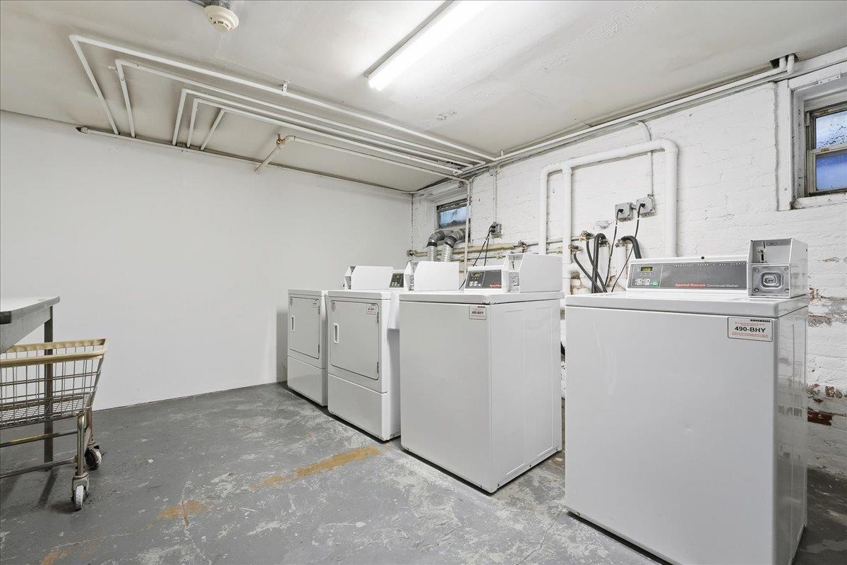 831 Clinton Street, Unit 9 Hoboken, NJ 07030 - Photo 14 of 20 a utility room with cabinets washer and dryer
