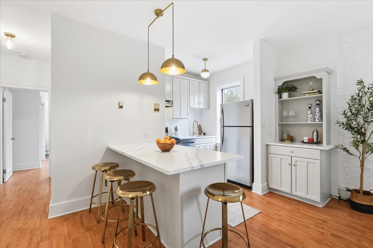 831 Clinton Street, Unit 9 Hoboken, NJ 07030 - Photo 18 of 20 a view of kitchen and dining room with wooden floor