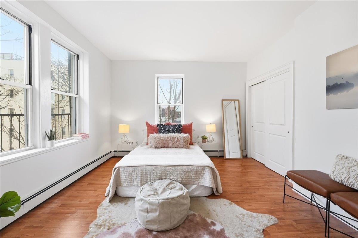 831 Clinton Street, Unit 9 Hoboken, NJ 07030 - Photo 10 of 20 a bedroom with a bed and wooden floor