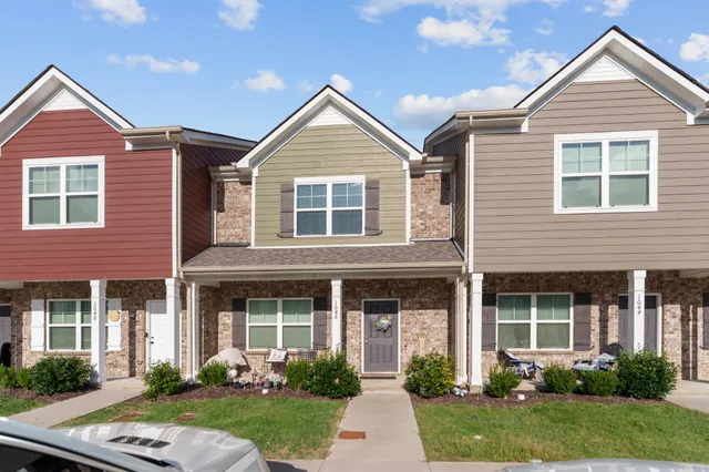 a front view of a house with garden and porch