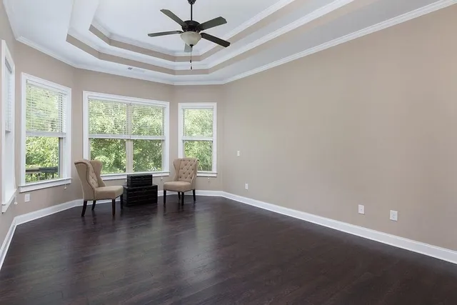 a view of a work space with wooden floor and a window