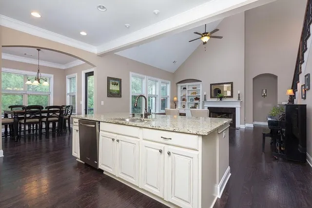 a kitchen with center island table and chairs