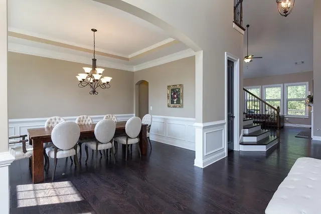 a view of a dining room with furniture wooden floor and chandelier