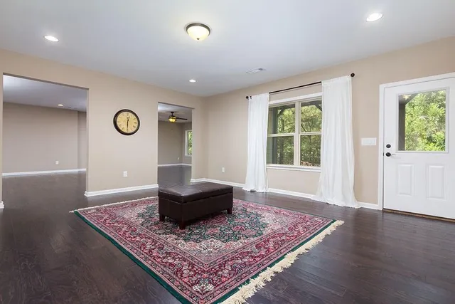 a living room with furniture and a rug