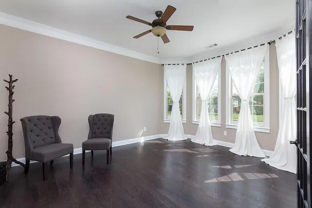 a view of room with furniture window and wooden floor