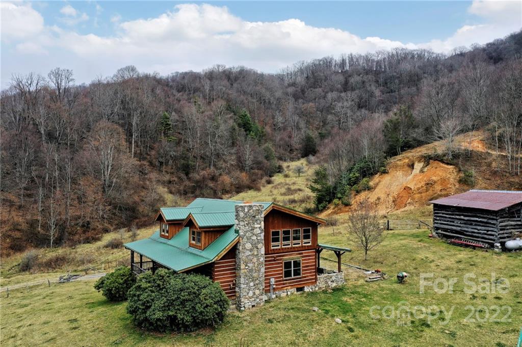 624 James Chapel Road Clyde, NC 28721 - Photo 1 of 46 a backyard of a house with lots of green space and mountain view