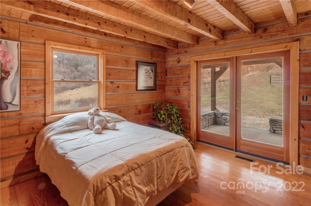 624 James Chapel Road Clyde, NC 28721 - Photo 13 of 46 a bedroom with a bed and a large window with outer view