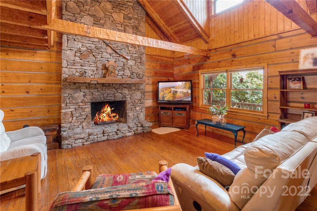 624 James Chapel Road Clyde, NC 28721 - Photo 7 of 46 a living room with furniture a fireplace and a flat screen tv
