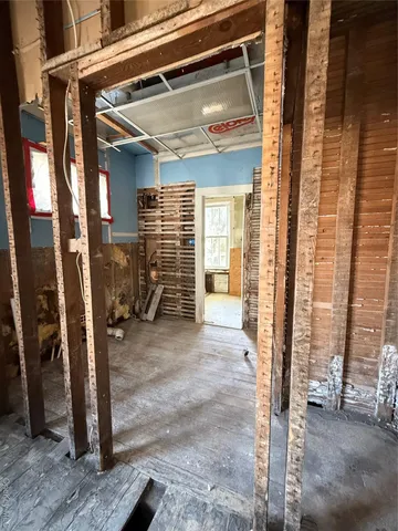 a view of staircase with railing and a mirror