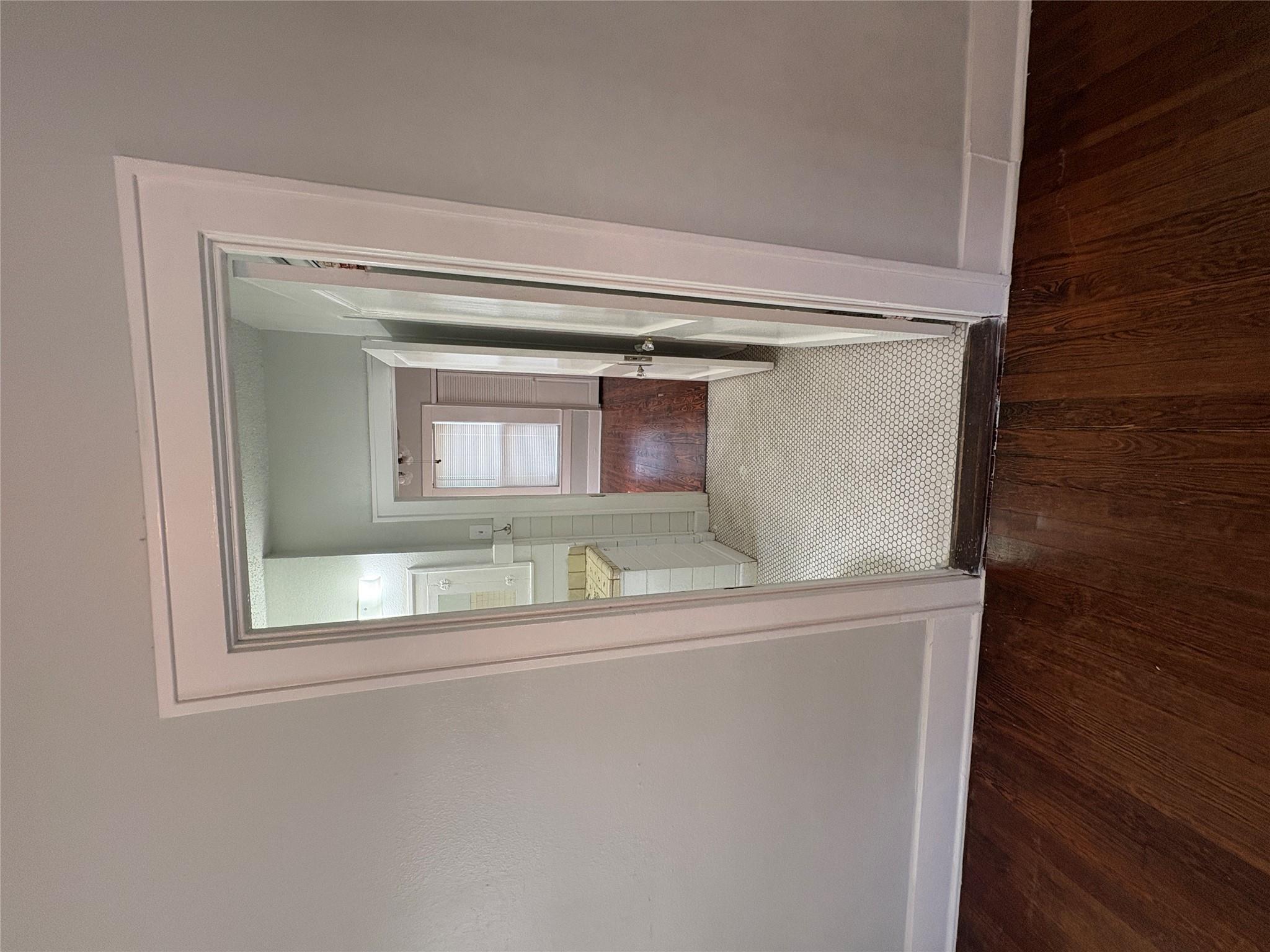 915 West 29th Street Austin, TX 78705 - Photo 6 of 20 Wood-finish flooring in the foreground and a doorway framed with white trim