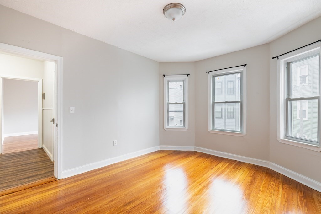 17 Cawfield Street, Unit 2 Boston, MA 02125 - Photo 4 of 14 a view of empty room with wooden floor and fan
