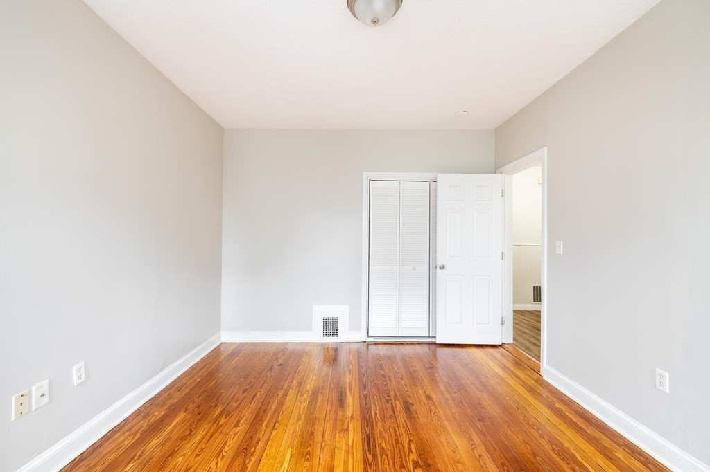17 Cawfield Street, Unit 2 Boston, MA 02125 - Photo 6 of 14 a view of an empty room with wooden floor and a window