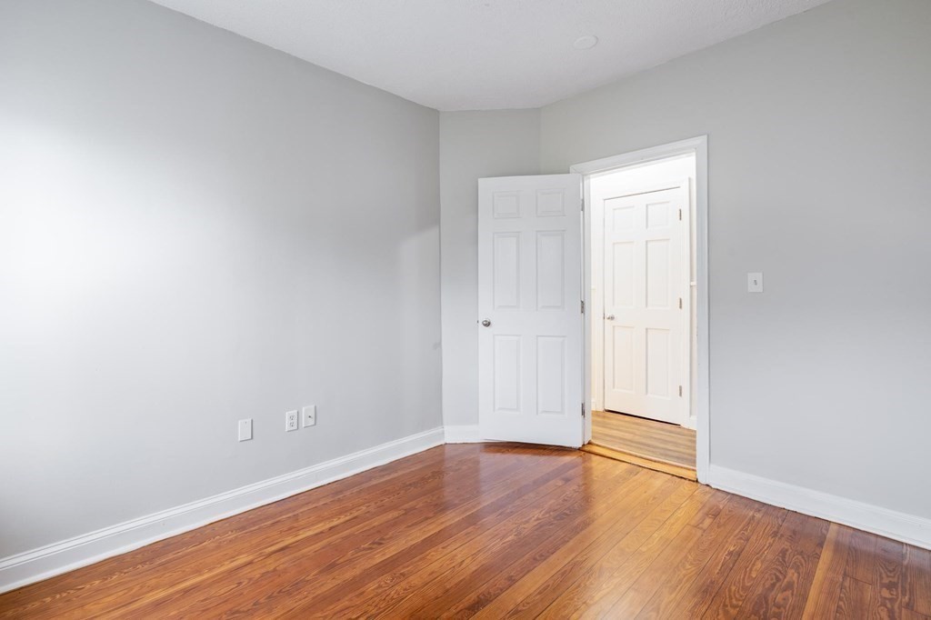 17 Cawfield Street, Unit 2 Boston, MA 02125 - Photo 8 of 14 a view of an empty room with wooden floor
