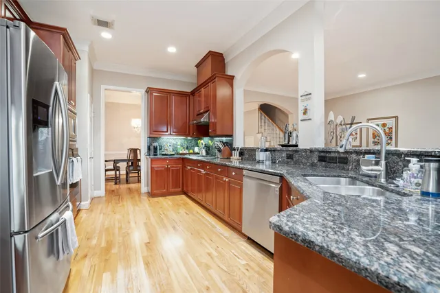 a kitchen with stainless steel appliances granite countertop a stove and a sink