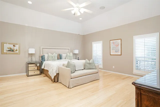 a spacious bedroom with a large bed and a chandelier