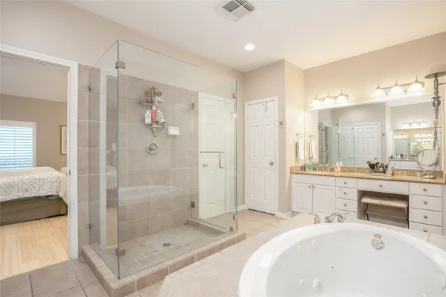 a large bathroom with a tub shower vanity and a sink