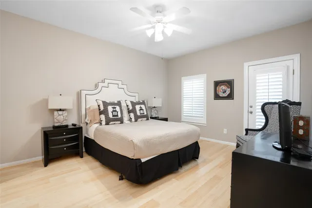 a spacious bedroom with a bed and a chandelier