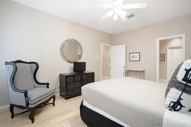 a bedroom with a bed a chair and piano