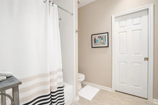 a bathroom with a shower and a toilet