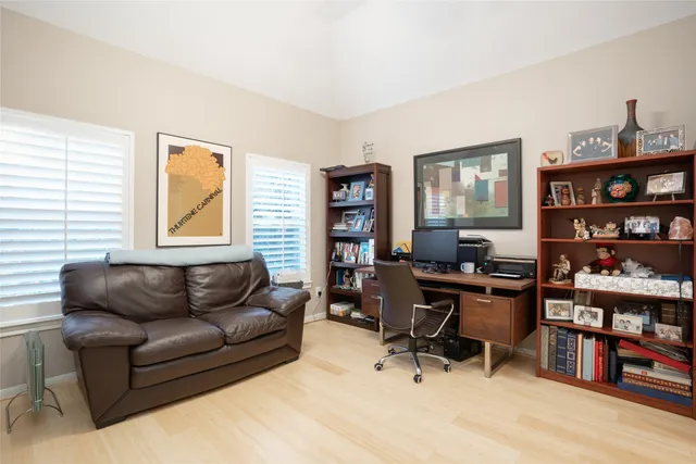 a livingroom with workspace and a couch
