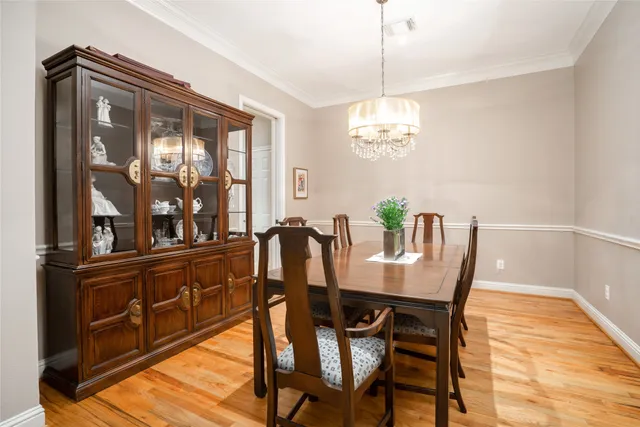 a view of a dining room with furniture wooden floor and chandelier