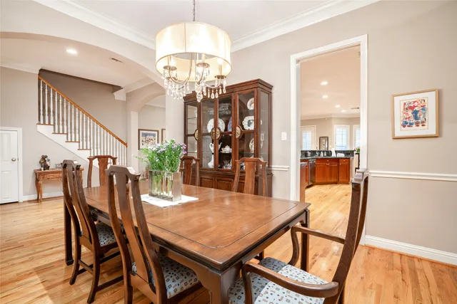 a view of a dining room with furniture and a chandelier