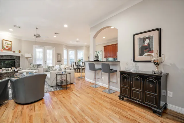 a living room with furniture a fireplace and a kitchen view
