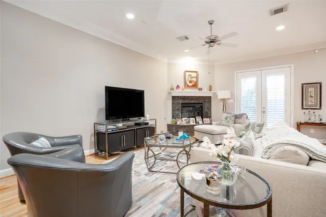 a living room with furniture a fireplace and a flat screen tv