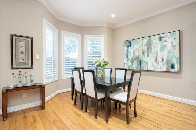 a dining room with furniture and wooden floor