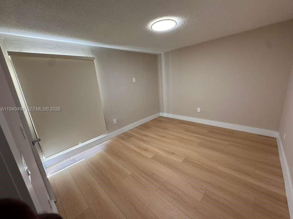 1990 West 56th Street, Unit 1311 Hialeah, FL 33012 - Photo 12 of 14 wooden floor in an empty room