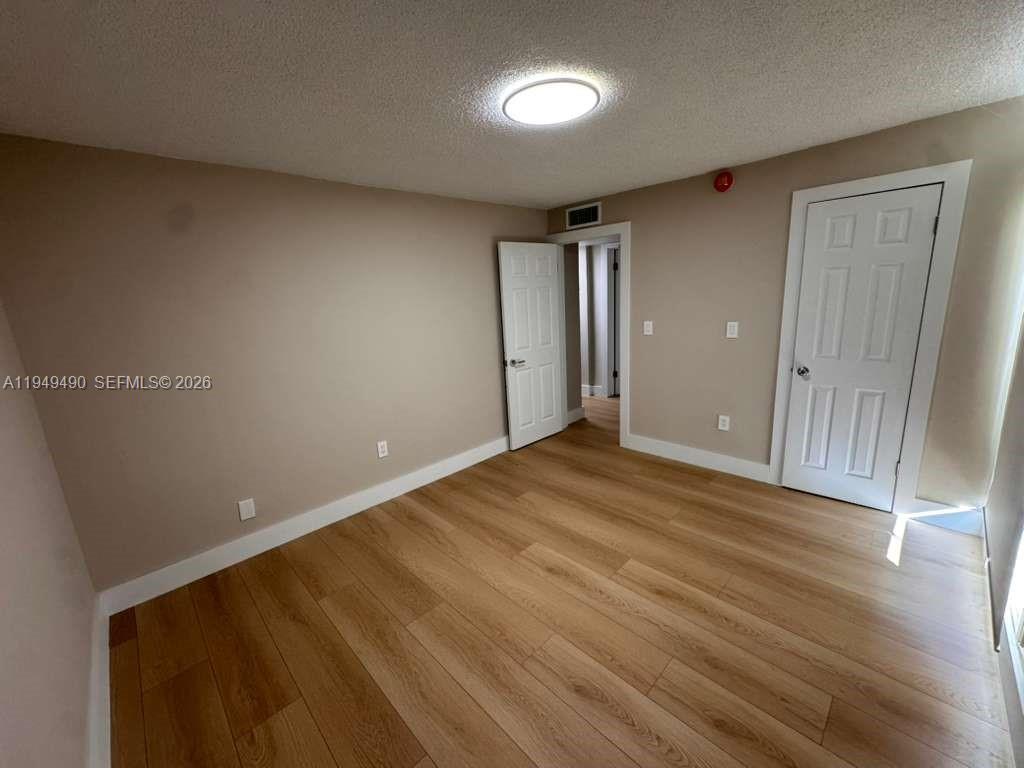 1990 West 56th Street, Unit 1311 Hialeah, FL 33012 - Photo 13 of 14 a view of empty room with wooden floor